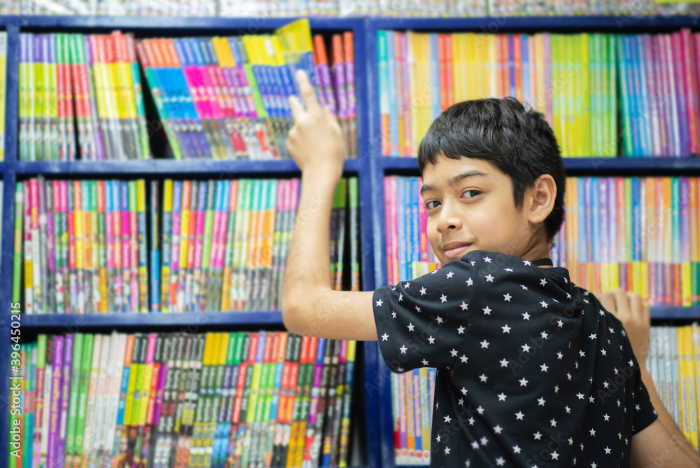 Teen boy looking for books to buy at bookstore Teen boy looking for books to buy at bookstore