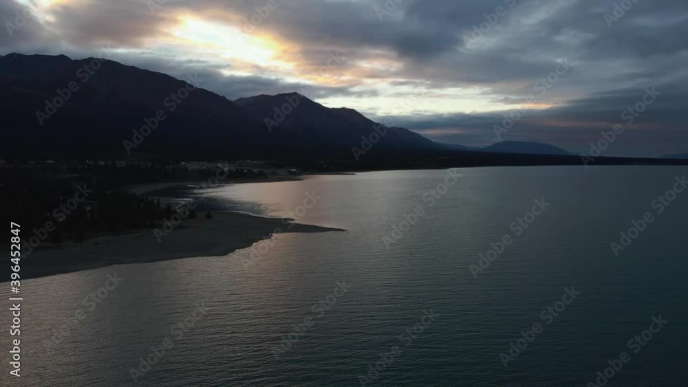 Kluane Lake silhouetted during colorful sunset in winter, aerial drone Kluane Lake silhouetted during colorful sunset in winter, aerial drone