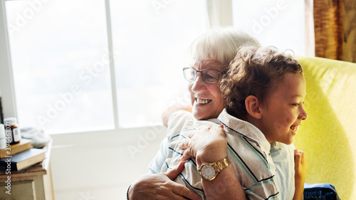 Fotografie Grandma and grandson hugging after social distancing