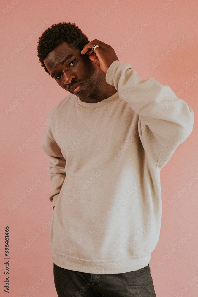 African American man wearing white sweater mockup on pink background African American man wearing white sweater mockup on pink background