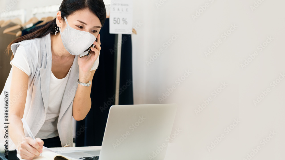 Retail sales in mask talking on the phone with copy space Retail sales in mask talking on the phone with copy space