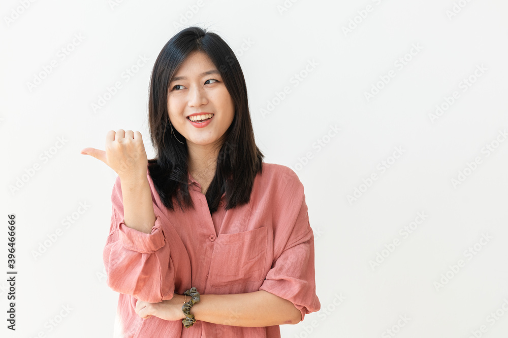 Beautiful cheerful woman standing by a white wall Beautiful cheerful woman standing by a white wall