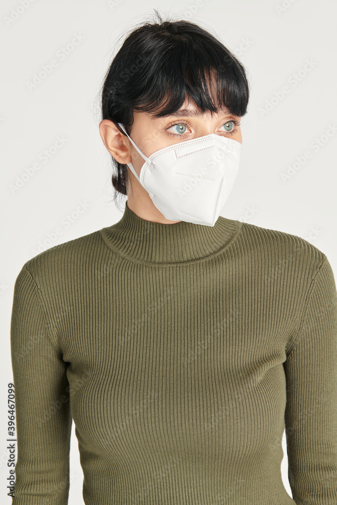Face mask mockup on a women in a green turtleneck top Face mask mockup on a women in a green turtleneck top