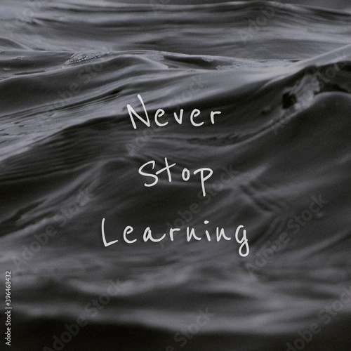 Never stop learning quote on a water wave background photo