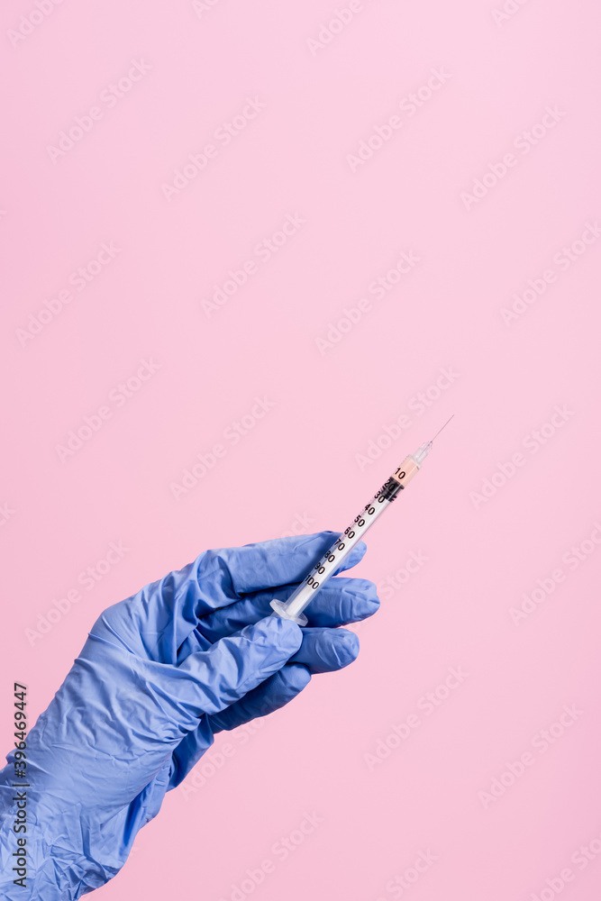 cropped view of hand in blue latex glove with syringe isolated on pink, stock image cropped view of hand in blue latex glove with syringe isolated on pink, stock image