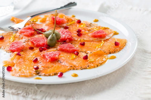 Salmon carpaccio with pink grapefruit and pomegranate