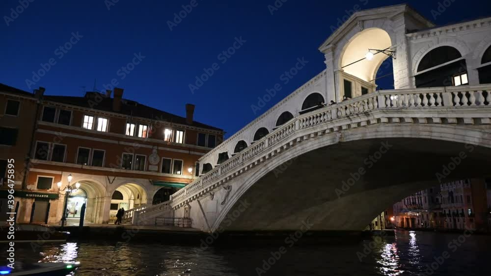 
Venice, Italy - November 2020 - The Rialto bridge and the Grand Canal light up at sunset with a thousand colors and reflections