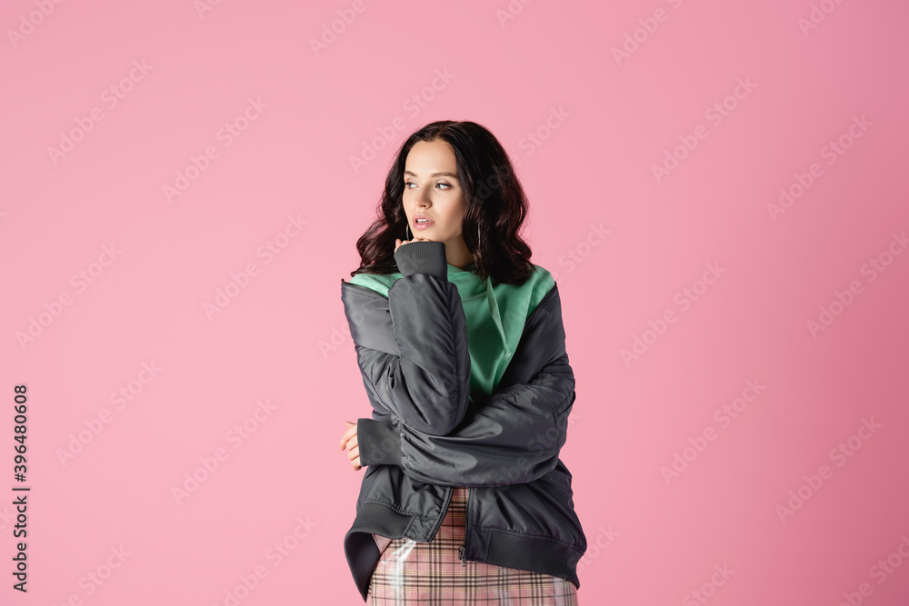brunette young woman in casual winter outfit posing on pink background brunette young woman in casual winter outfit posing on pink background