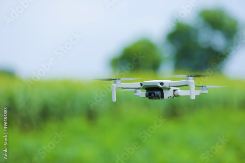 Close up view of flying drone over agriculture field