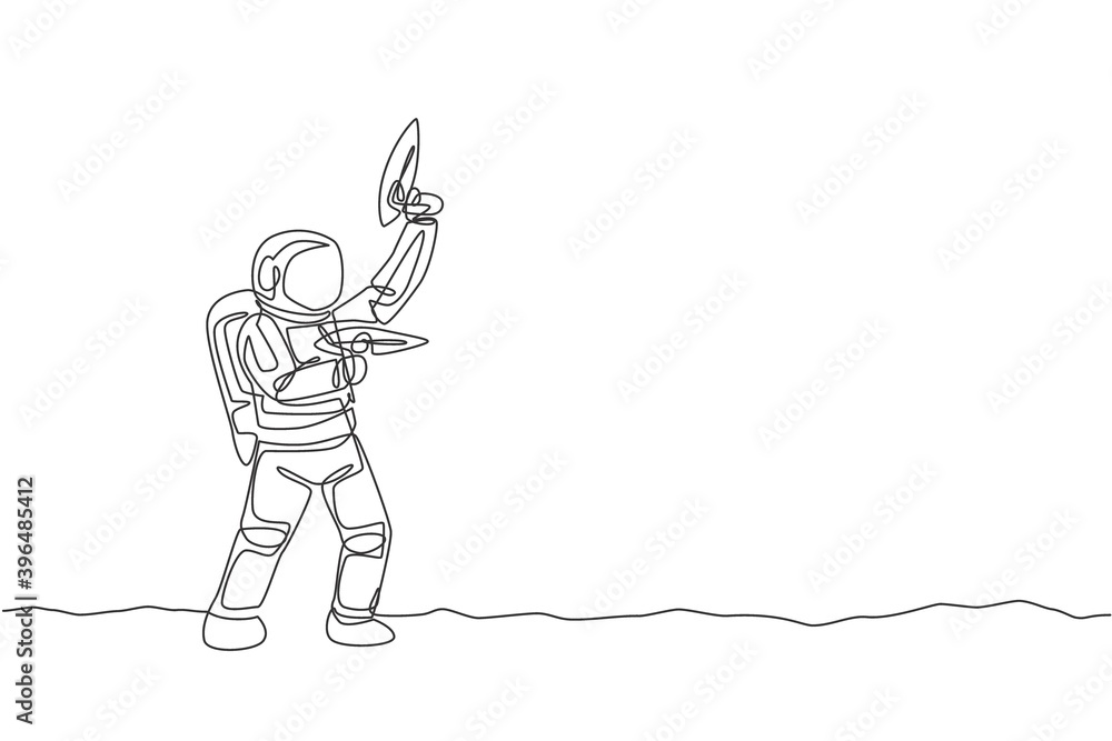 Fototapeta premium One continuous line drawing of young astronaut shoot using space laser gun to kill enemy in moon surface. Cosmic galaxy space concept. Dynamic single line draw graphic design vector illustration
