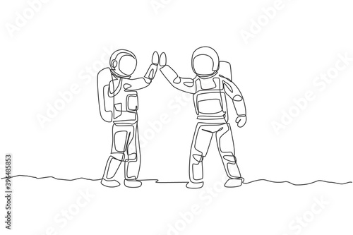 One single line drawing of two young happy astronauts gave high five while meeting on the street in moon surface vector illustration. Cosmonaut outer space concept. Modern continuous line draw design