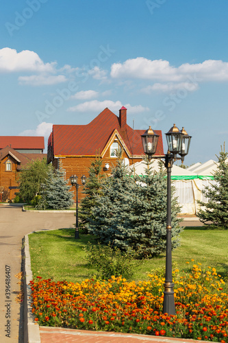 Beautifully designed landscape with flower bed and trees