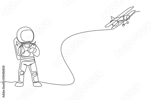One single line drawing of astronaut playing airplane radio control in moon land graphic vector illustration. Doing hobby while leisure time in deep space concept. Modern continuous line draw design