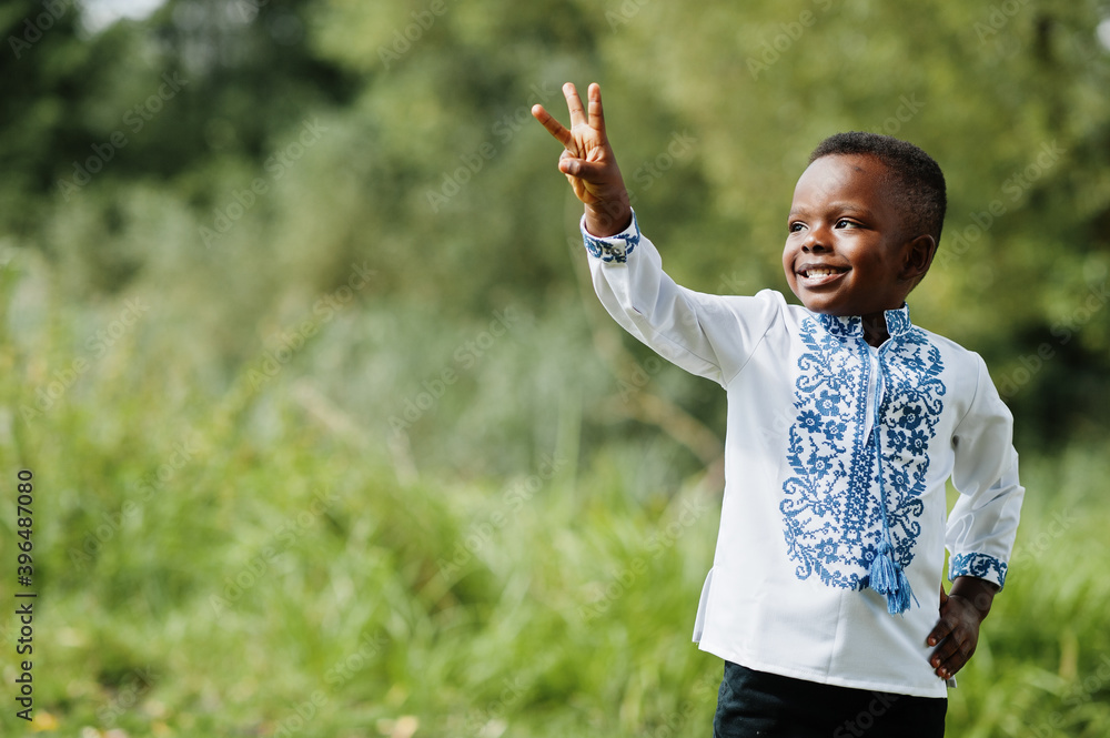 Portrait of african boy kid in traditional clothes at park. Portrait of african boy kid in traditional clothes at park.