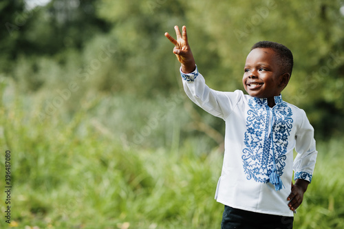 Portrait of african boy kid in traditional clothes at park.