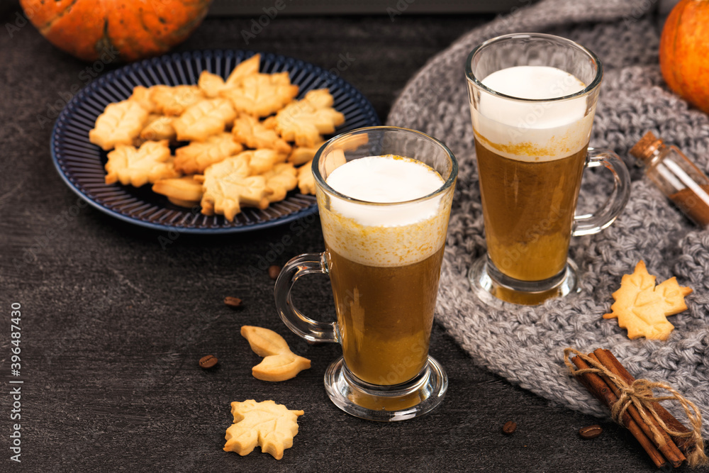 Pumpkin sweet spicy latte with autumn cookies and cinnamon. Grey knitted plaid Pumpkin sweet spicy latte with autumn cookies and cinnamon. Grey knitted plaid