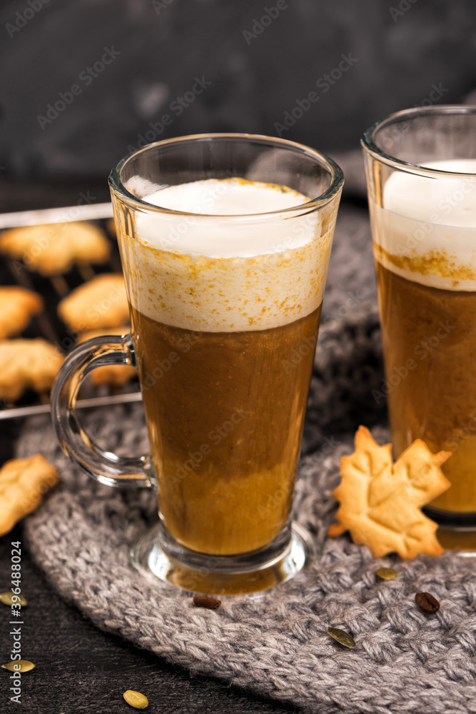 Pumpkin sweet spicy latte with autumn cookies and cinnamon. Grey knitted plaid Pumpkin sweet spicy latte with autumn cookies and cinnamon. Grey knitted plaid