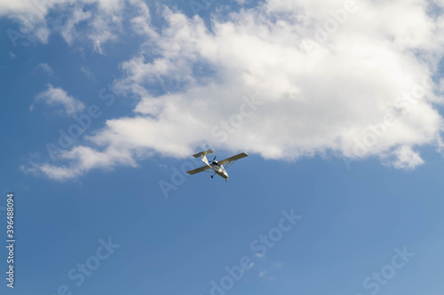 Small plane flying in the blue sky