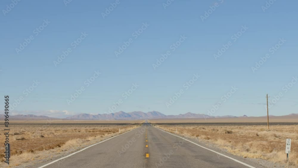Tilt Down on Wide Open Empty Desert Highway in Nevada - Shallow Depth of Field Tilt Down on Wide Open Empty Desert Highway in Nevada - Shallow Depth of Field