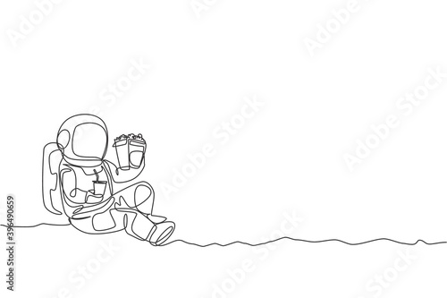 Single continuous line drawing of spaceman sitting relax on moon surface while eating french fries and drinking soft soda. Outer space life concept. Trendy one line draw design vector illustration