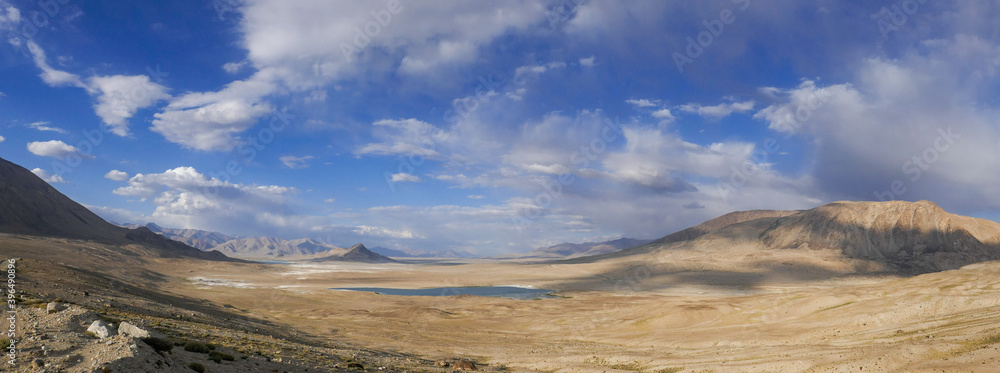 Spectacular view of high-altitude Tuzkul salt lake with mountain background along the Pamir Highway between Bulunkul and Alichur in Gorno-Badakshan, Tajikistan