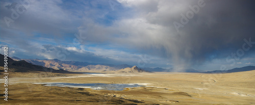 Spectacular panoramic view of high-altitude Tuzkul salt lake with mountain background and coming storm along the Pamir Highway between Bulunkul and Alichur in Gorno-Badakshan, Tajikistan © Cyril Redor