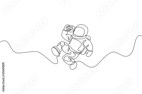 Single continuous line drawing of spaceman relaxing and eating sweet glazed donut in nebula galaxy. Fantasy fiction of outer space life concept. Trendy one line draw design graphic vector illustration