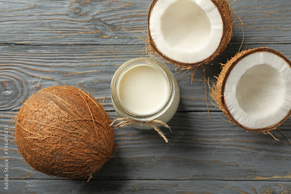 Fresh coconut and coconut milk on wooden background Fresh coconut and coconut milk on wooden background