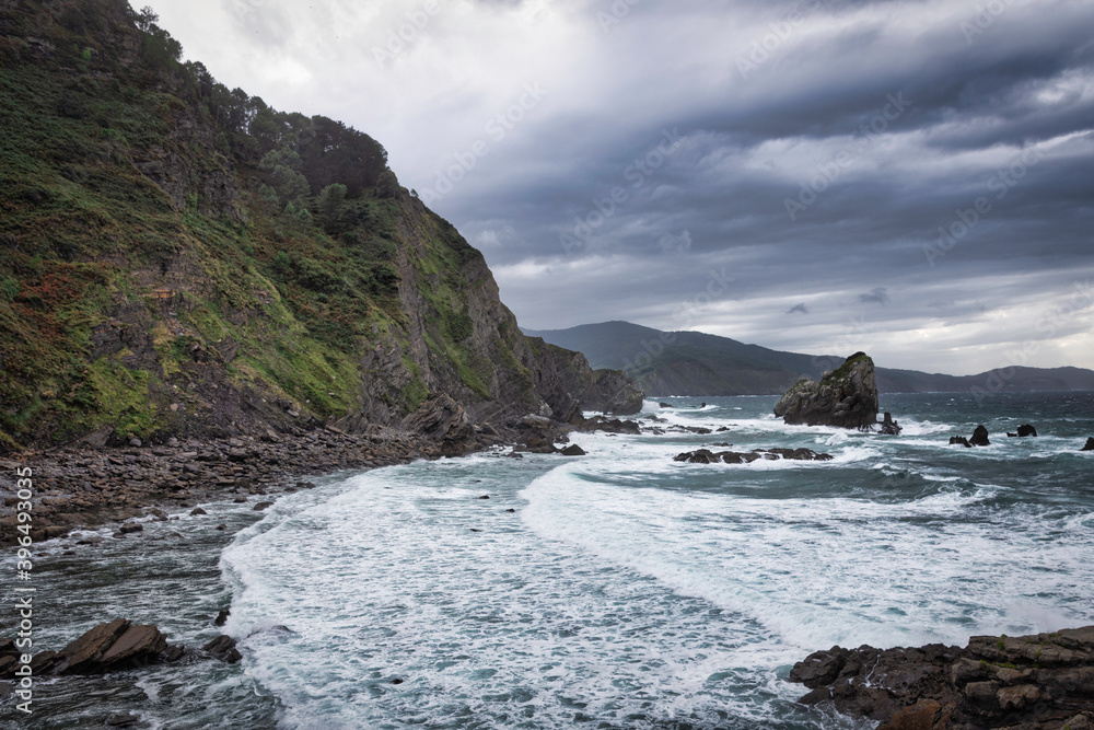 Obraz premium natural beach with cliff has a dramatic effect with the clouds