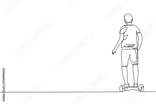 One continuous line drawing young happy man stand and ride hoverboard at outdoor park. Green transportation. Future urban lifestyle concept. Dynamic single line draw design vector graphic illustration