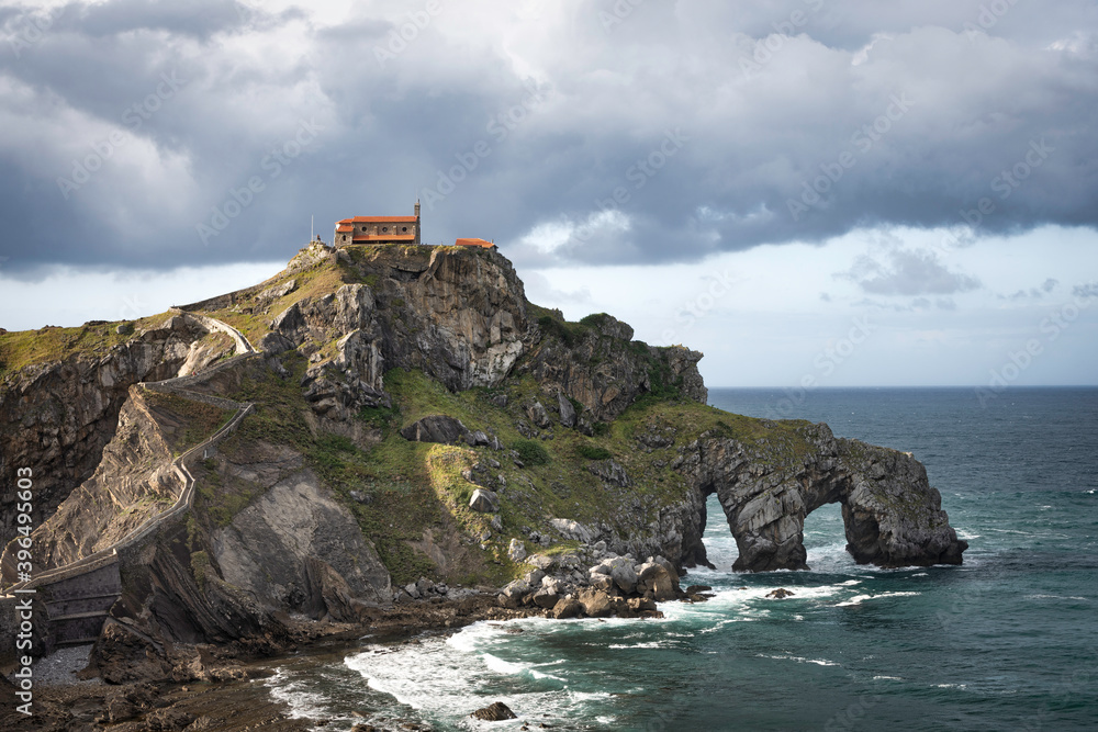 beautiful dramatic and cloudy landscape of a hermitage on a rock mountain within the sea