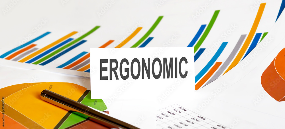 ERGONOMIC text on paper on chart background with pen ERGONOMIC text on paper on chart background with pen