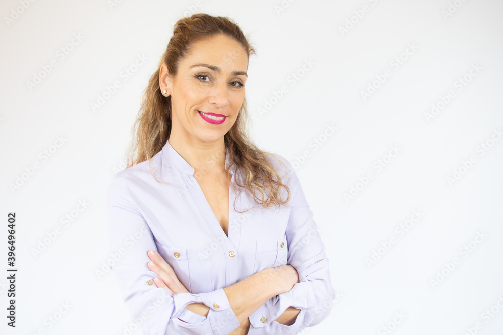 Portrait of a smiling young woman standing with arms folded isolated over white background Portrait of a smiling young woman standing with arms folded isolated over white background