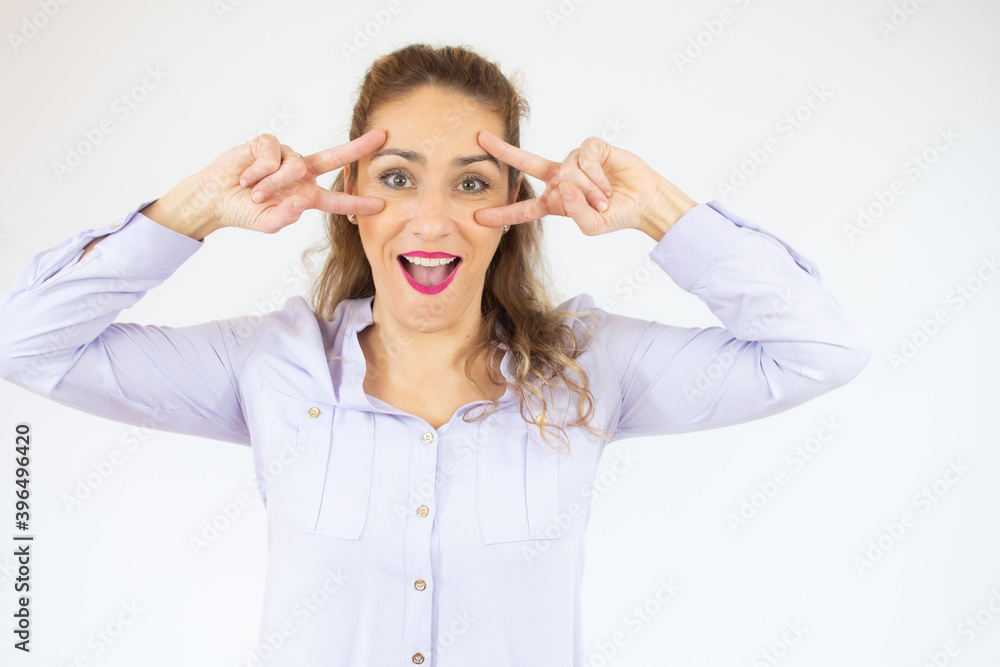 Young caucasian woman isolated showing victory sign and smiling over white background. Young caucasian woman isolated showing victory sign and smiling over white background.