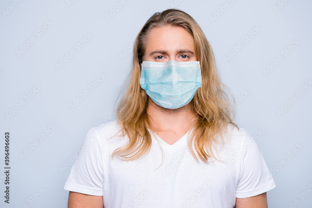 Photo of handsome serious confident young guy blonde long hair facial respirator isolated grey color background Photo of handsome serious confident young guy blonde long hair facial respirator isolated grey color background
