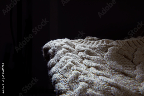 Texture of a knitted sweater over black background 