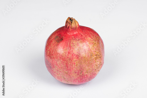 Large red pomegranate against white background