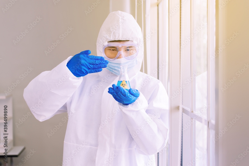 Chemist man smelling test medical chemicals sample in glass volumetric ...