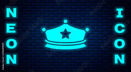 Glowing neon Police cap with cockade icon isolated on brick wall background. Police hat sign. Vector.