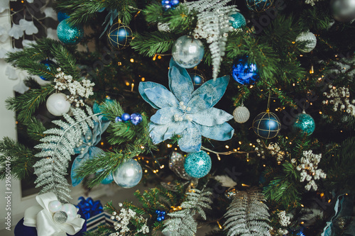 Close up of christmas trees decoration with toys and garlands.