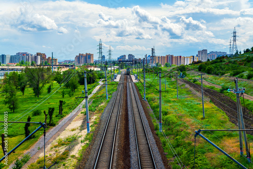 Straight railroad track in industrial area of city