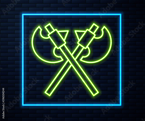 Glowing neon line Crossed medieval axes icon isolated on brick wall background. Battle axe, executioner axe. Medieval weapon. Vector.