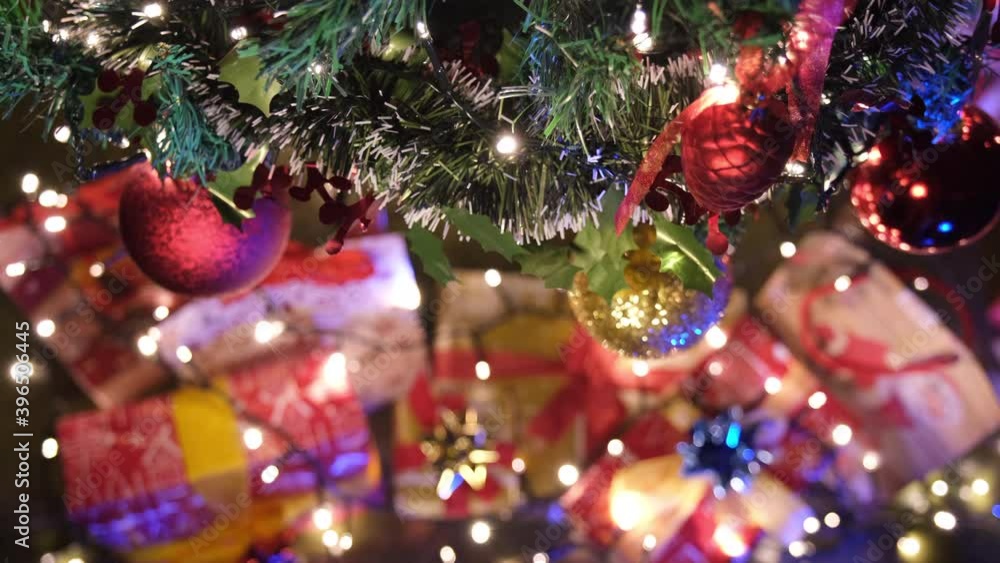 Christmas tree decoration with ball bauble and gifts in home living room. Winter night celebration. Christmas tree decoration with ball bauble and gifts in home living room. Winter night celebration.