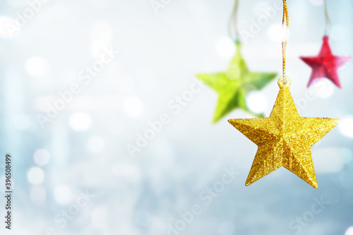 Colorful Christmas star hanging with blurred light background