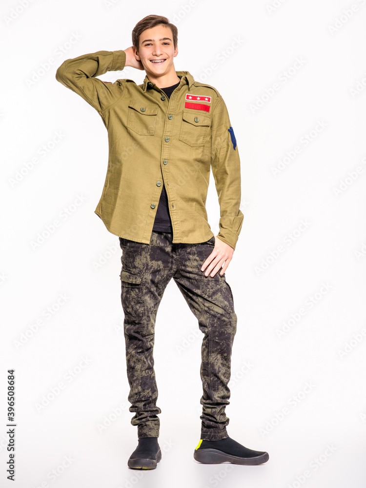 Smiling young man in camouflage clothing. Happy Conscript in camouflage. Cheerful rookie in army clothes. Teenager in khaki military clothing. Smiling young man in camouflage clothing. Happy Conscript in camouflage. Cheerful rookie in army clothes. Teenager in khaki military clothing.