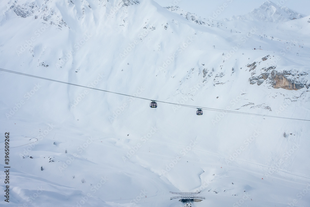 Winter landscape in the Alps. chalet house in Mayrhofen sports region in the Zillertal. Two ski cabins against the mountains Winter landscape in the Alps. chalet house in Mayrhofen sports region in the Zillertal. Two ski cabins against the mountains
