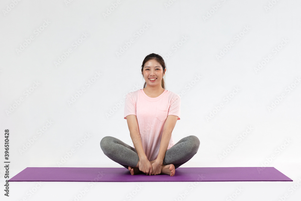 Cute Asian woman wearing sportswear making relaxed pose isolated on white background, concept Yoga and exercise Cute Asian woman wearing sportswear making relaxed pose isolated on white background, concept Yoga and exercise