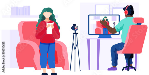 Girl in a red sweater is standing near the chair, shoots video and text from paper on a camera. A man with headphones is sitting at a table with a laptop and recording a video report of a girl