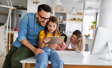 Happy family spending time at home and using digital, technology devices.