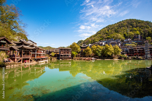 the river, the boat, stone bridge and the old houses at ancient phoenix town in the morning at Hunan, China.